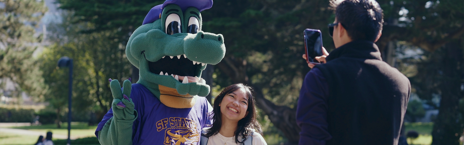 Alli Gator get a picture with a student